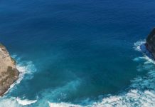 Banner Turquoise ocean sea water white wave pattern splashing deep blue sea. Banner Tropical sea beach Seascape dark background wave splash on rock. Summer Ocean Surface big wave with copy space