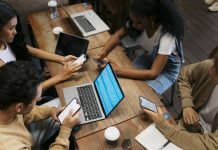 College students e-learning over their smart phones in a coffee shop