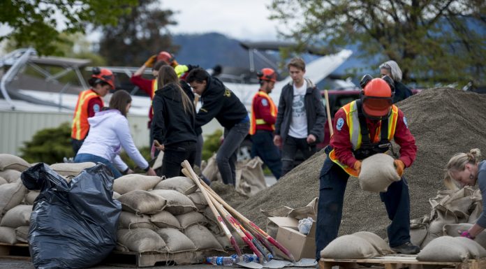 KELOWNA, CANADA - MAY 12: An emergency response worker piles sandbags on a pallette on May 12, 2017 in Kelowna, British Columbia, Canada.