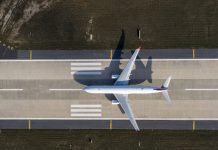 Aerial drone photo of air planes as seen from above docked in airport space