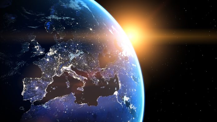 Planet Earth viewed from space with glowing city lights. Europe view. World with shine sunrise from the space.