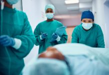 Female team of surgeons taking patient out of the operating room