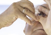 Mature Man Using Eye Drops