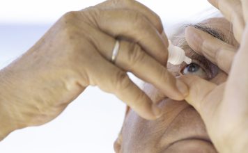 Mature Man Using Eye Drops