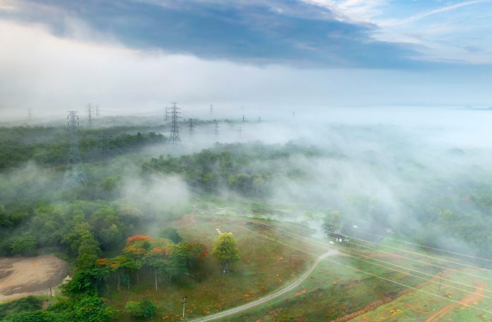Field of high voltage transmission poles In the morning, it was foggy.