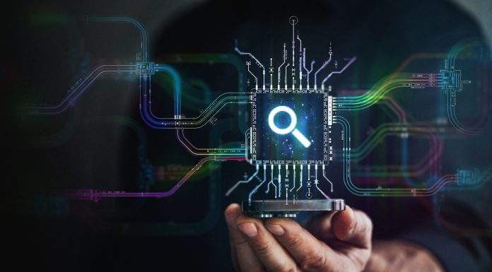 Search in your hand. A hand holds digital lens icon in the center and circuit board with vibrant data transfers, representing evolving search technology of the future.