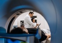 n a bright diagnostic center, a young man undergoes a CT or MRI scan using modern equipment. This image reflects the forefront of medical technology, emphasizing precision and patient care.