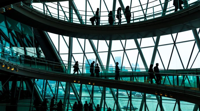 Abstract modern architecture and silhouettes of people on spiral staircase