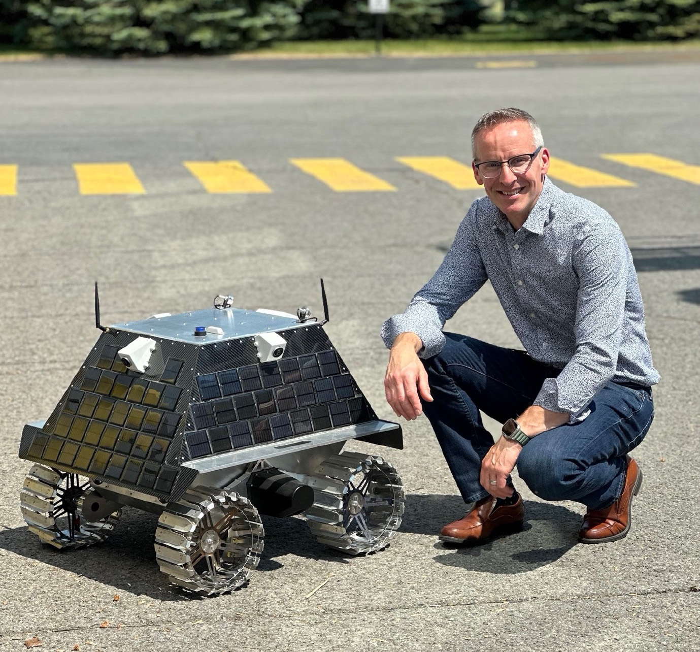 Dr. Gordon Osinski for scale next to an early prototype of the Canadian lunar rover
