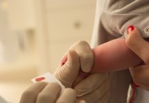 closeup of examining foot in newborn, (foot test)