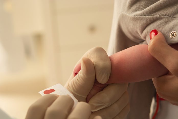 closeup of examining foot in newborn, (foot test)