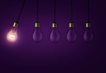 European Commission and private investors launch multi-billion Scale-up Europe Fund Creative light bulb lights up other extinguished light bulbs on a dark purple background, concept. Leadership, creative idea. Think differently. Start up