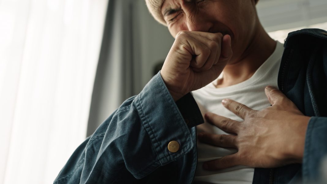 Young asian man was suffering from painful chest pain from a chronic disease.