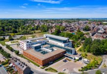 Aerial photo of the Pontefract Hospital located in the village of Pontefract in Wakefield in the UK on a sunny summers day showing the Hospital and grounds with a blue sky and white clouds in the sky