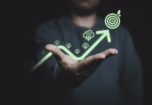 Glowing of green up arrow with carbon reduction on businessman until achievement environment target for decrease CO2 , carbon footprint and carbon credit to limit global warming from climate change.