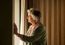 Pensive senior woman at home thinking