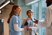 Happy nurse on a meeting with hospital administrator and doctor.