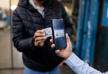 Close-up on an employee showing his ID card at the entrance of a factory