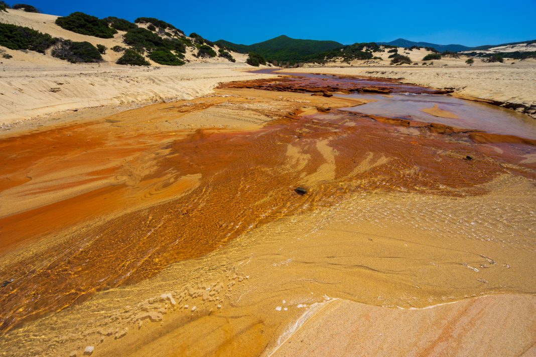 The heavily polluted Irvi River, which carries highly toxic heavy metals from the abandoned Montevecchio mine to the Spiaggia di Piscinas beach, Sardinia, Italy