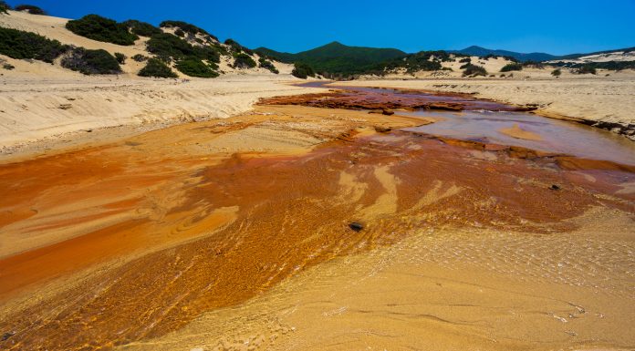 The heavily polluted Irvi River, which carries highly toxic heavy metals from the abandoned Montevecchio mine to the Spiaggia di Piscinas beach, Sardinia, Italy