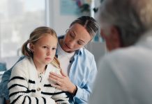 Woman, doctor and child in clinic for medical services, consultation or opinion. People, girl and pediatric patient in conversation for appointment, checkup and healthcare with treatment advice