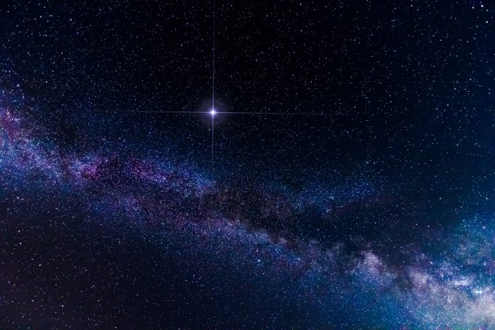 Amazing spike glowing lucky star and Milky Way Galaxy background