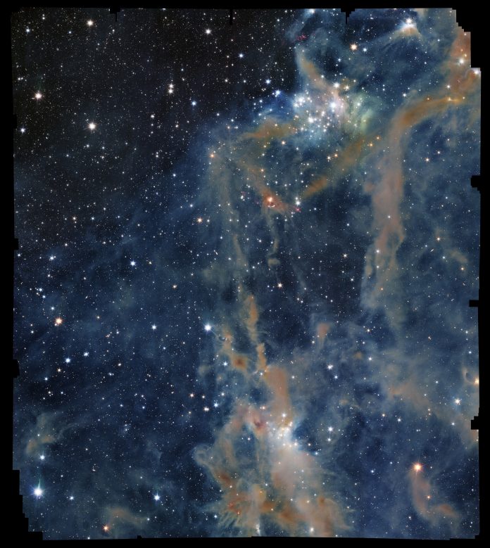 Image description: The focus of the image is a portion of LDN 1641, an interstellar nebula in the constellation of Orion. In this view, a deep-black background is sprinkled with a multitude of dots (stars) of different sizes and shades of bright white. Across the sea of stars, a web of fuzzy tendrils and ribbons in varying shades of orange and brown rises from the bottom of the image towards the top-right like thin coils of smoke.] CREDIT ESA/Euclid/Euclid Consortium/NASA, image processing by M. Schirmer (MPIA, Heidelberg)