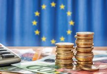 The EU has selected eight high-growth innovators for EIC STEP Scale Up investments Banknotes and coins in front of the flag of the European Union