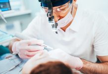 Dentist cleans tooth canals of patient and removes nerve - pulpitis treatment