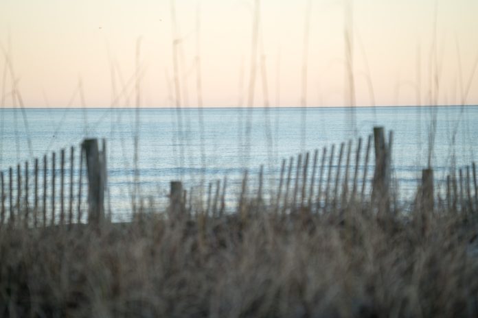 A clear view of the Atlantic Ocean through the blurred dunes at Wrightsville Beach, NC.
