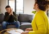 Youth suicide: An overview Selective focus shot of mid adult female therapist giving constructive advice to insecure teenage boy, that is struggling with negative emotions, sitting across from her on the sofa, during a therapy session.
