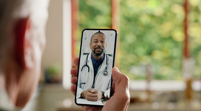 Man, cellphone screen and telehealth with doctor or online consultation at home or virtual advice, discussion or diagnosis. Patient, healthcare worker and internet conversation, service or futuristic
