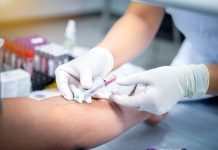 taking blood sample from a patient in the hospital.