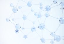 A close-up view of glowing molecular structures under a blue background representing scientific research and chemistry concepts