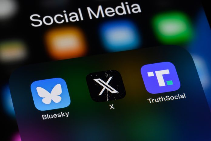 Toronto, Canada - December 13, 2024: Social media apps on a smartphone - Bluesky, X (formerly Twitter), Truth Social.