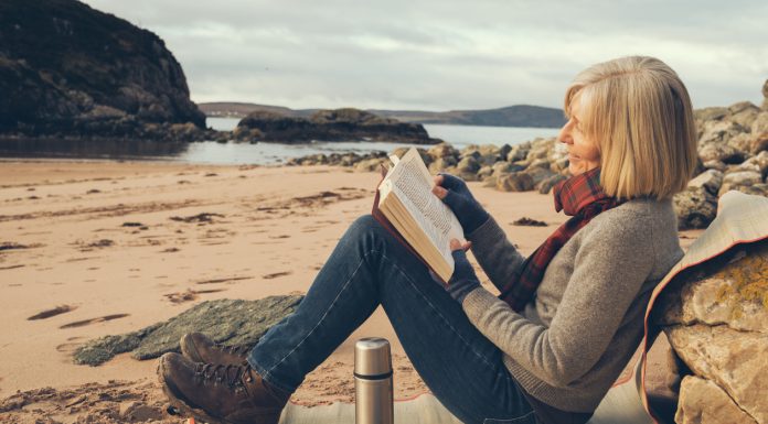 Senior woman on the beach at Gruinard Bay, Ross and Cromarty, Scotland. Off season, beach all to herself.