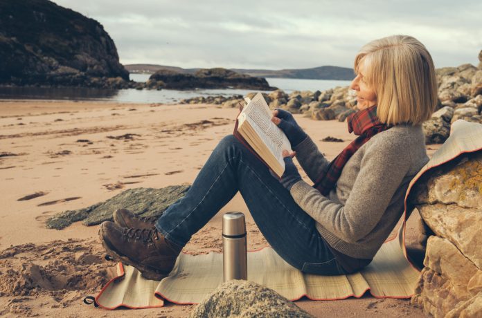 Time alone, beach, Gruinard Bay, Scotland Senior woman on the beach at Gruinard Bay, Ross and Cromarty, Scotland. Off season, beach all to herself.