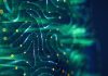 Abstract digital background featuring flowing blue and green lines with glowing yellow particles, evoking a sense of data flow or neural networks.