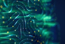 The future of brain interfacing Abstract digital background featuring flowing blue and green lines with glowing yellow particles, evoking a sense of data flow or neural networks.