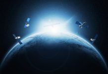 Artificial Satellites Orbiting Earth in Space with Sunrise on the Horizon and Starry Background