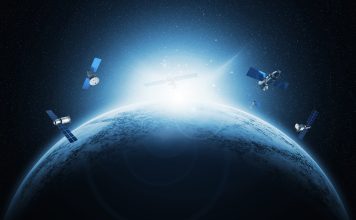 UK space agency funds new studies to tackle global space debris challenges Artificial Satellites Orbiting Earth in Space with Sunrise on the Horizon and Starry Background