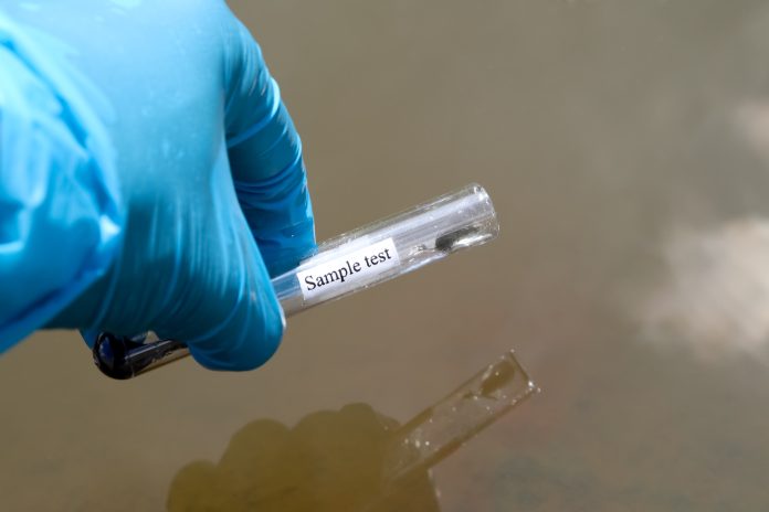 Collect samples of wastewater from industrial canals in test tubes to be examined in the laboratory