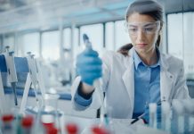 Medical Research Laboratory: Portrait of a Beautiful Female Scientist in Goggles Using Micro Pipette for Test Analysis. Advanced Scientific Lab for Medicine, Biotechnology, Microbiology Development