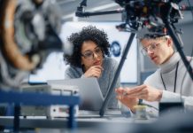 Diverse Engineers Discussing New Powerful Microchip to Put it Inside the Modern Drone. Technological Startup and Innovative Technologies in Unmanned Aerial Vehicle Concept.