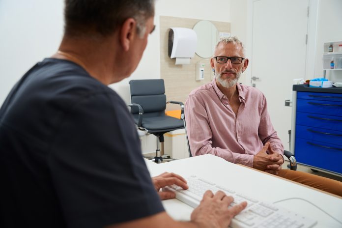 Bearded male with glasses at a doctors appointment Bearded male with glasses at a doctors appointment