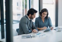 Business people, teamwork and tablet for statistics, finance report and planning of revenue, profit or sales in office. Professional advisor or clients with data analytics, graphs and digital charts