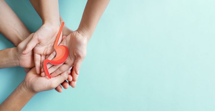 Hands holding stomach, heartburn, Gastroesophageal reflux disease (GERD) or acid reflux symptom, health care concept