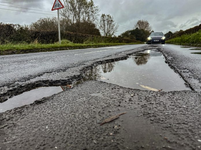 Potentially tyre-ripping potholes in a road in East Sussex, UK. Like many other parts of the world potholes are a major political issue in the UK. On many (not all) roads they are the responsibiity of local authorities, which say they simply don't have the funds to fix them. They are often fixed with patches, using different tarmac to that on the rest of the road; it expands and contracts at a different rate in the UK's cold, wet winters and increasingly hot summers, which leads to faster cracking and frost damage. EVs (heavier, because of the batteries) are allegedly making the situation worse.
