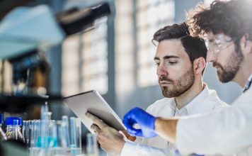 two scientist using digital tablet in laboratory