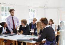 Teenage Students Listening To Teacher In Art Class